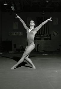 Female gymnast posing on floor