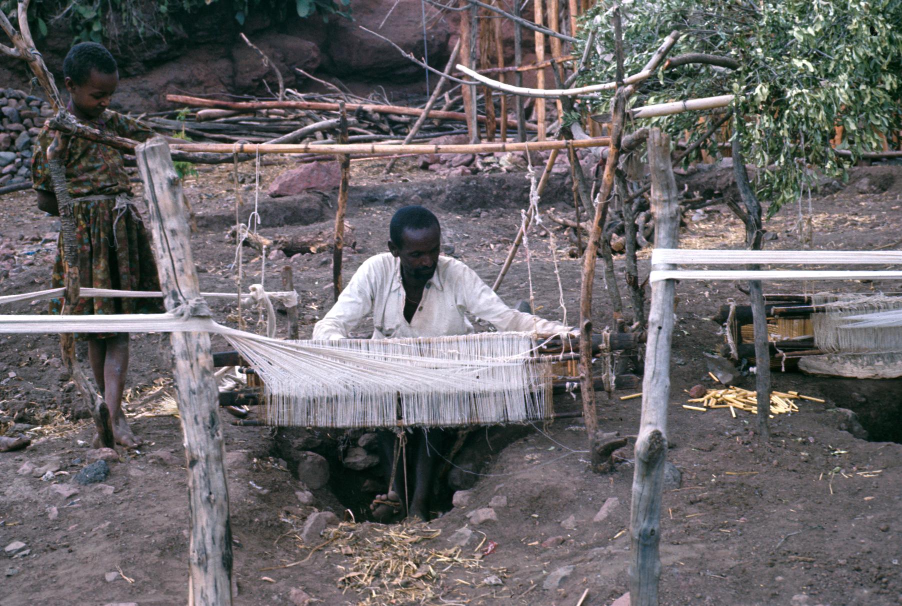 Man Weaving at Pit Loom