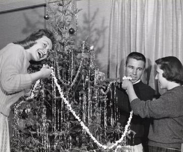Hanging popcorn chains on a Christmas tree